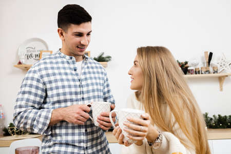 Portrait of a young sweet couple in kitchenの写真素材