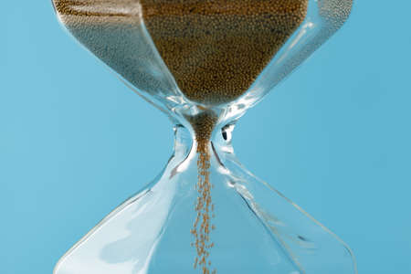 Close up of sandglass on paper background