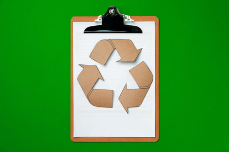 Paper recycling concept on green background top viewの写真素材