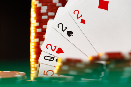 Poker chips and playing cards on black background