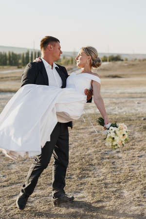 Happy bride and groom looking at each other with a smileの写真素材