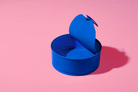 Aesthetic concept with blue painted tin can on pink backgroundの写真素材
