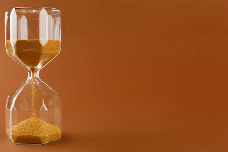 Close up of sandglass on paper backgroundの写真素材