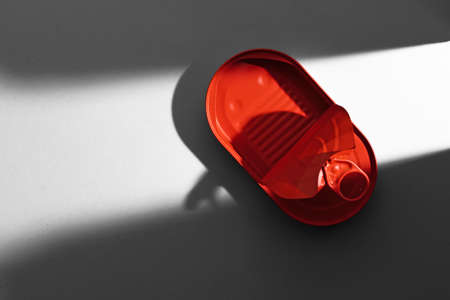 Red painted open tin can on gray backgroundの写真素材