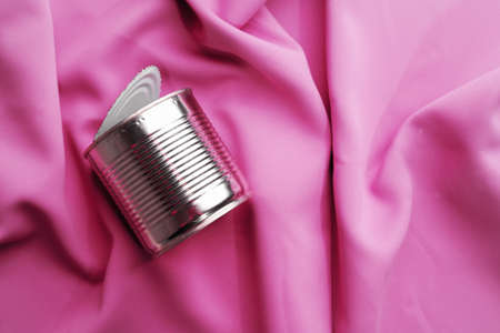 Tin can on pink silky fabric, aesthetic conceptの写真素材