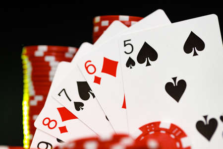 Red playing chips and cards on poker tableの写真素材