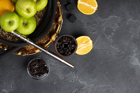 Shisha parts with apples and lemons on tableの写真素材