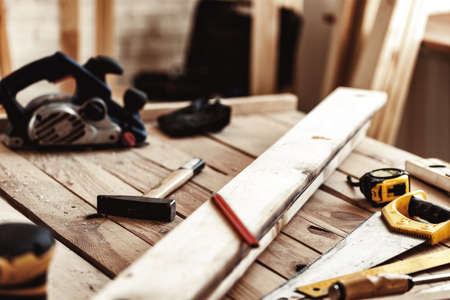 Hand saw on a wooden table in carpentry workshop