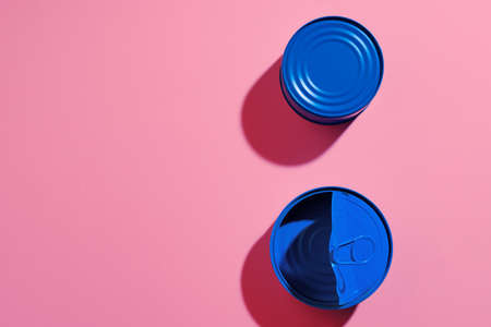 Aesthetic concept with blue painted tin can on pink backgroundの写真素材