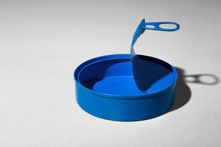 Blue tin can on gray background with shadowの写真素材