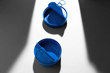 Painted blue opened tin can with ring on white backgroundの写真素材