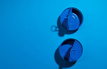 Blue tin can on blue background close upの写真素材