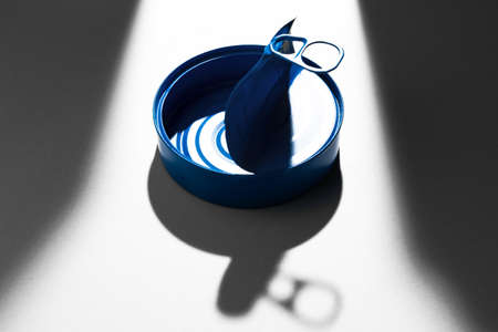 Painted blue opened tin can with ring on white backgroundの写真素材