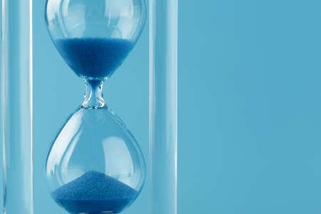Close up of sandglass on paper background