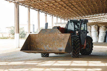 Old agriculture tractor working on a farmの写真素材