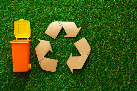 Garbage sorting concept with toy waste bin on paper backgroundの写真素材