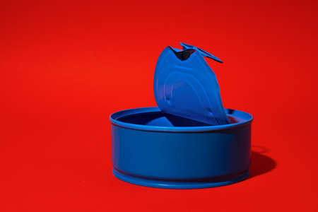 Blue tin can on dark red backgroundの写真素材