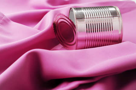 Tin can on pink silky fabric, aesthetic conceptの写真素材