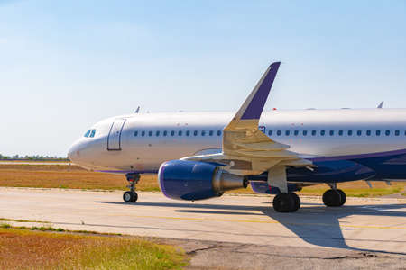 Big passenger airplane drives along the runway in airportの写真素材