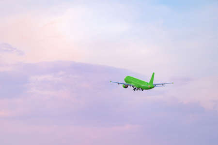 Passenger airplane flying against clear blue skyの写真素材