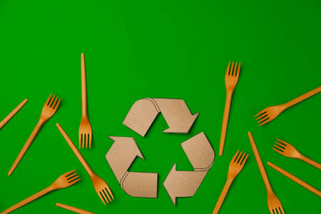 Zero waste disposable tableware forks on green background