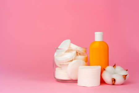 Stack of cotton discs and skicare cosmetic bottleの写真素材