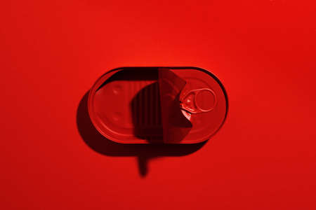 Dark red tin can on red backgroundの写真素材