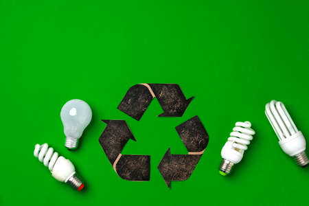 Light bulb and recycling sign on green backgroundの写真素材