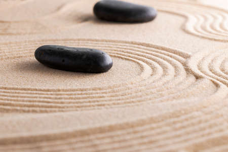 Japanese zen garden with stone in raked sand