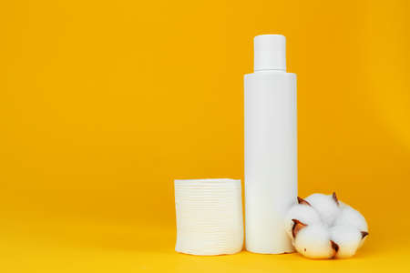 Stack of cotton discs and skicare cosmetic bottleの写真素材