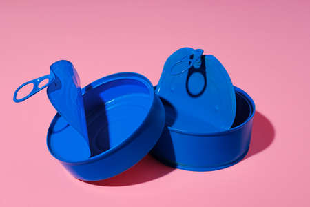 Aesthetic concept with blue painted tin can on pink backgroundの写真素材