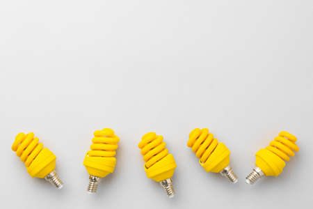 Light bulb on light grey paper backgroundの写真素材