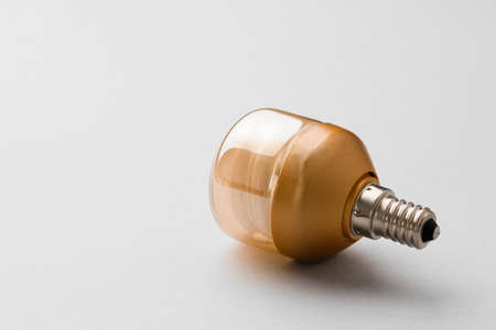 Light bulb on light grey paper background