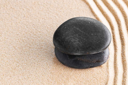 Japanese zen garden with stone in raked sand