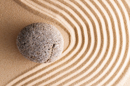 Japanese zen garden with stone in raked sand