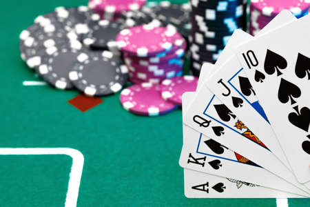 Playing cards and chips on green casino table background