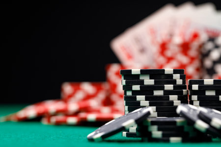 Poker chips and playing cards on black backgroundの写真素材