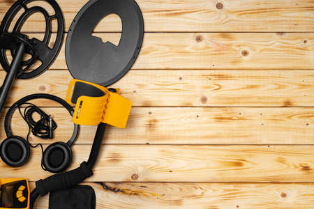 Accessories for metal detector on wooden backgroundの写真素材