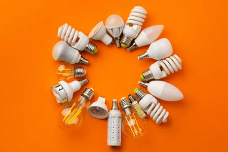 Many light bulbs on bright orange background