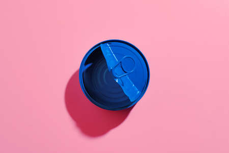 Aesthetic concept with blue painted tin can on pink backgroundの写真素材