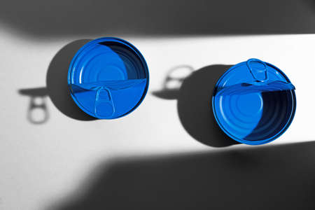 Painted blue opened tin can with ring on white backgroundの写真素材