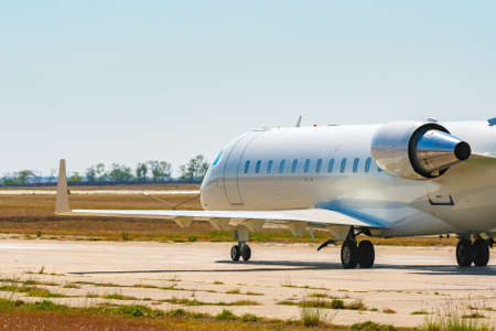 Big passenger airplane drives along the runway in airport