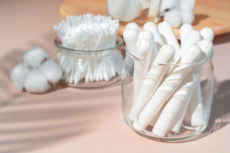 Cotton tampons and ear buds on paper background