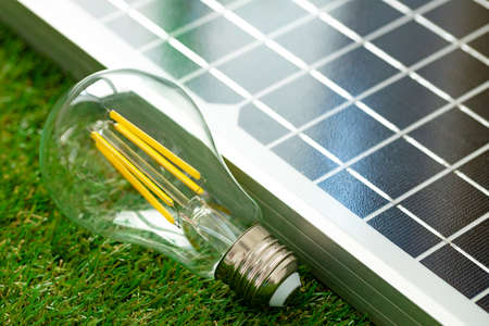 Solar energy panel and light bulb, green energyの写真素材