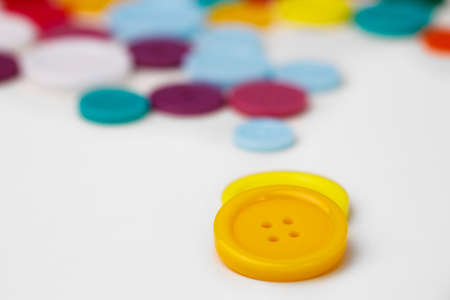 Assortment of colorful buttons on white background
