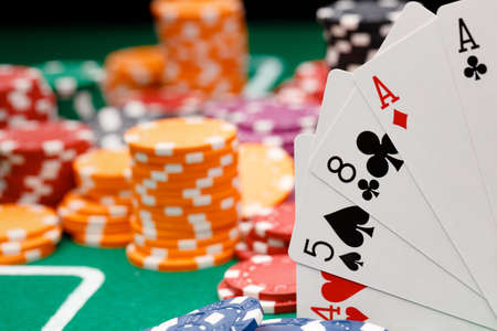Playing cards and chips on green casino table background