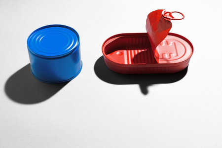 Red and blue painted tin cans on gray backgroundの写真素材