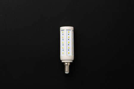 One light bulb on black background top view