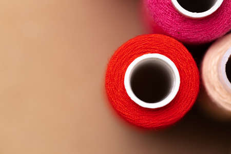 Many colored spools of threads as a background