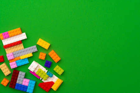 Details of kids plastic constructor on green background
